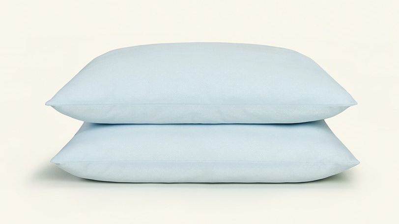 Two blue pillows lay on each other. The SlumberCloud UltraCool Pillow is the best pillow for staying cool in 2022.